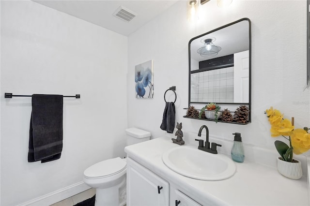 bathroom with tile patterned flooring, vanity, toilet, and a shower