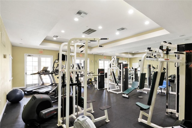 exercise room featuring a tray ceiling