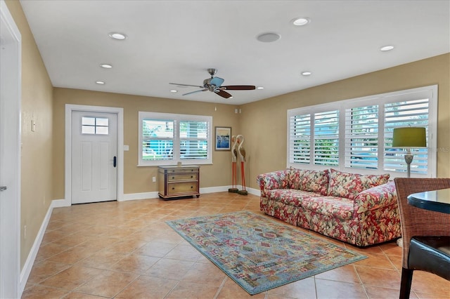 living room with ceiling fan and light tile patterned floors