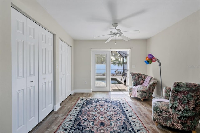 sitting room with wood-type flooring and ceiling fan