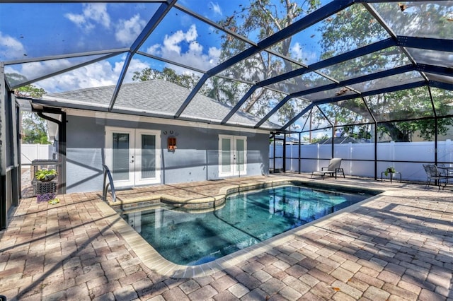 view of swimming pool featuring a patio, a lanai, and french doors