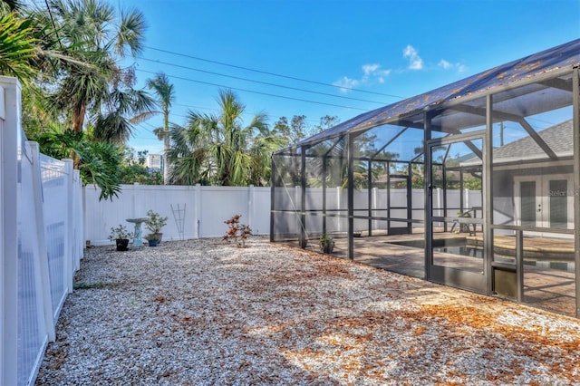 view of yard featuring glass enclosure