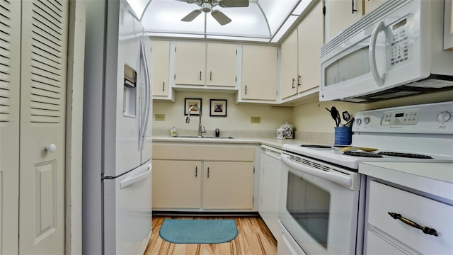 kitchen with light hardwood / wood-style floors, white cabinetry, sink, ceiling fan, and white appliances