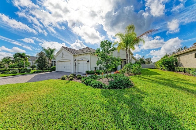 view of front facade with a front yard and a garage