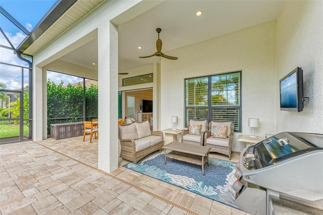 view of patio / terrace featuring outdoor lounge area, ceiling fan, glass enclosure, and a grill