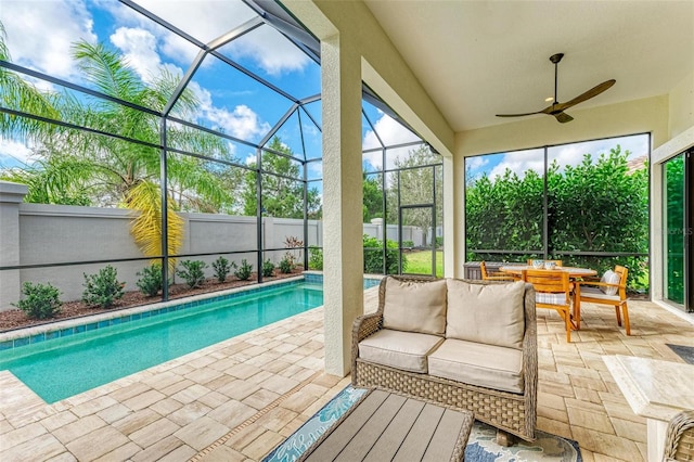 view of pool featuring a patio area, ceiling fan, and glass enclosure