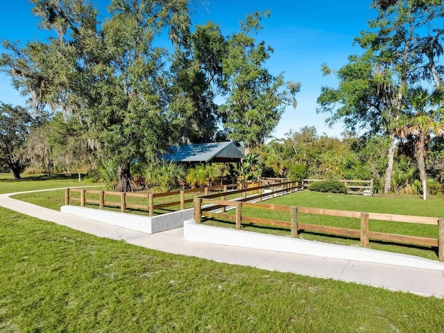 view of home's community featuring a gazebo, a rural view, and a lawn