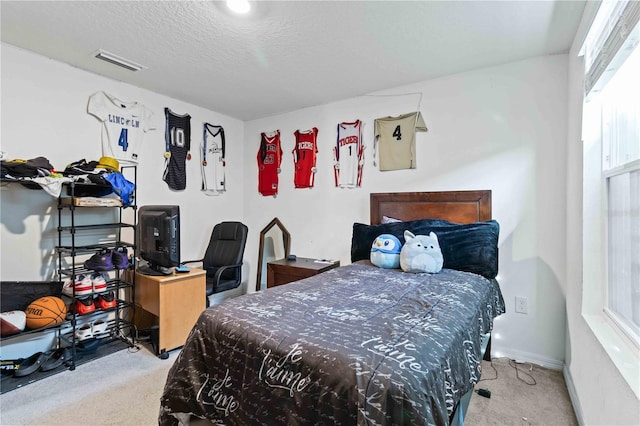 carpeted bedroom with a textured ceiling