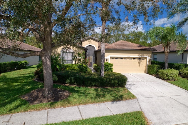 view of front of home featuring a front lawn and a garage