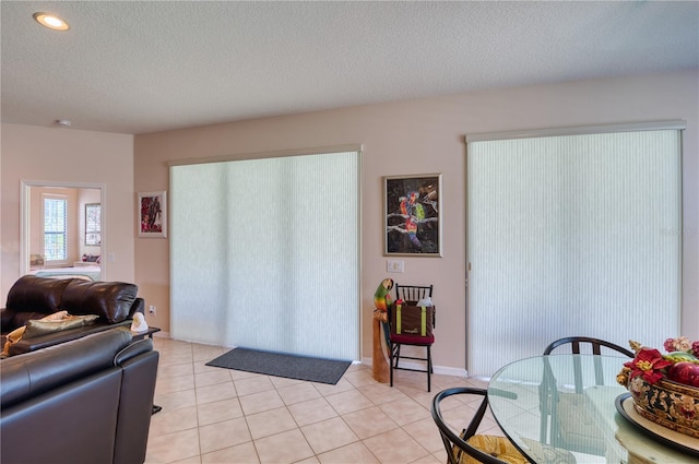 living room with light tile patterned floors and a textured ceiling