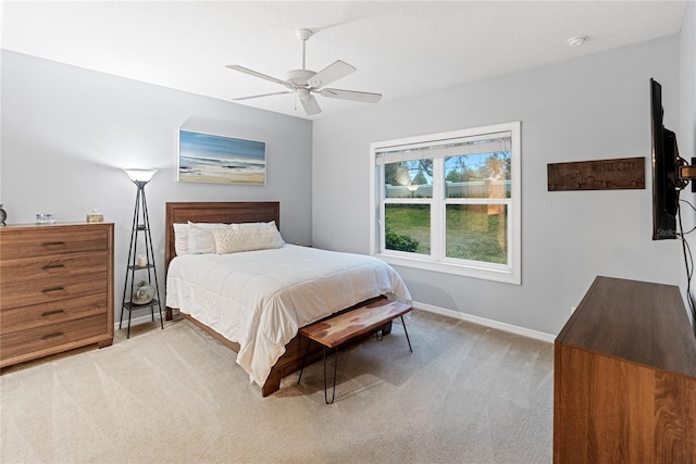 bedroom featuring light colored carpet and ceiling fan