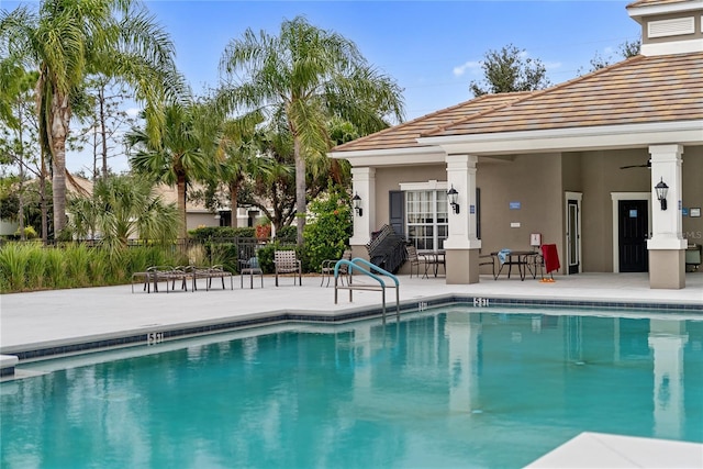 view of pool with a patio area and ceiling fan