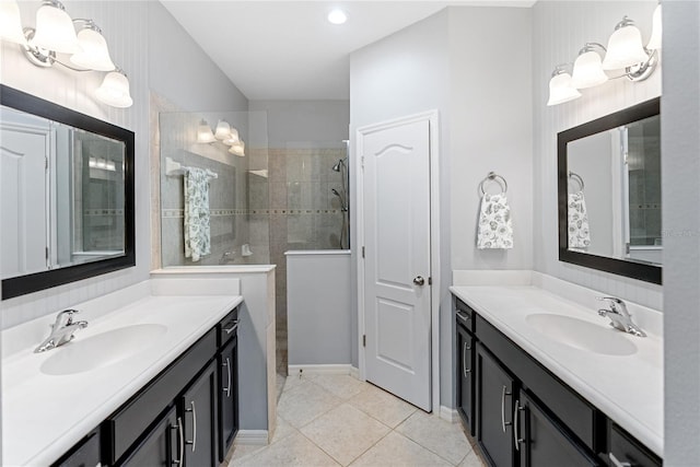 bathroom with vanity, tile patterned flooring, and tiled shower