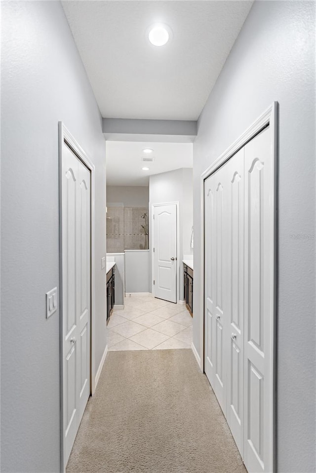 hall with light tile patterned flooring