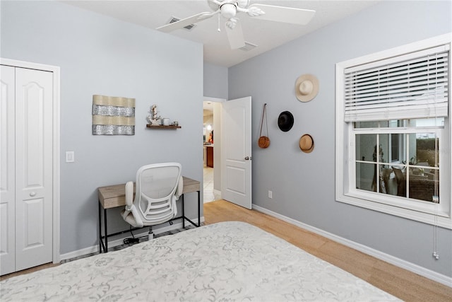 bedroom featuring ceiling fan and a closet