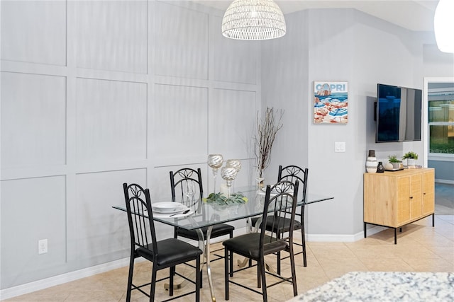 dining area featuring an inviting chandelier and light tile patterned flooring