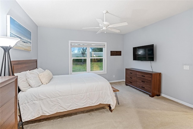 bedroom featuring ceiling fan and light carpet