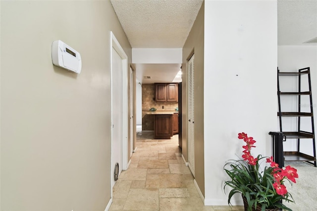 corridor featuring a textured ceiling