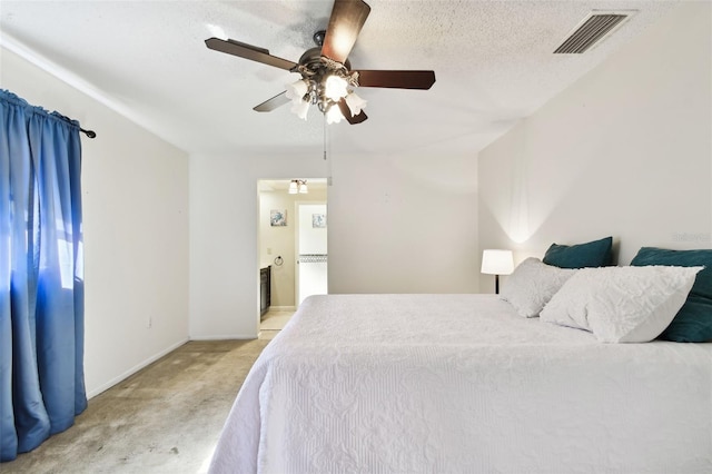 bedroom featuring ceiling fan, light colored carpet, and a textured ceiling