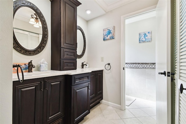 bathroom with tile patterned flooring, vanity, and ornamental molding