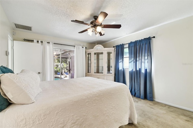 carpeted bedroom with a textured ceiling, access to outside, and ceiling fan