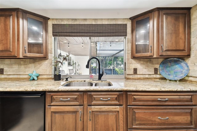 117 Hillcrest Dr, Bradenton, FL 34209 - kitchen featuring light stone countertops, glass insert cabinets, tasteful backsplash, a sink, and dishwasher