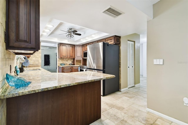117 Hillcrest Dr, Bradenton, FL 34209 - kitchen with visible vents, baseboards, ceiling fan, a raised ceiling, and appliances with stainless steel finishes