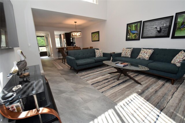 1508 Pelican Cove Rd Unit Gr233, Sarasota, FL 34231 - living room featuring a chandelier