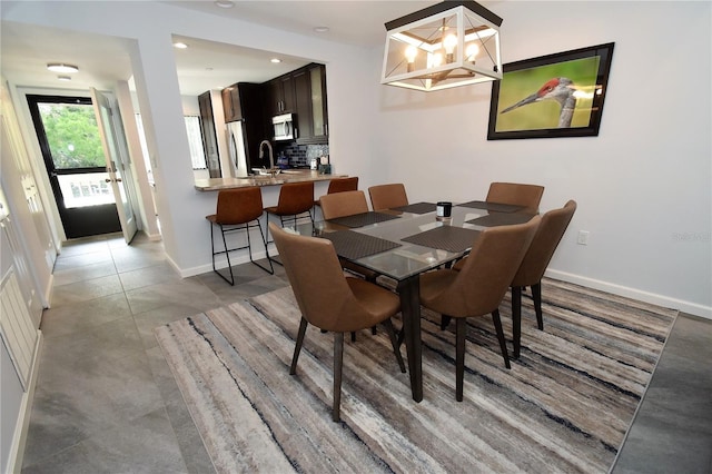1508 Pelican Cove Rd Unit Gr233, Sarasota, FL 34231 - dining area with baseboards, a chandelier, recessed lighting, and light tile patterned flooring