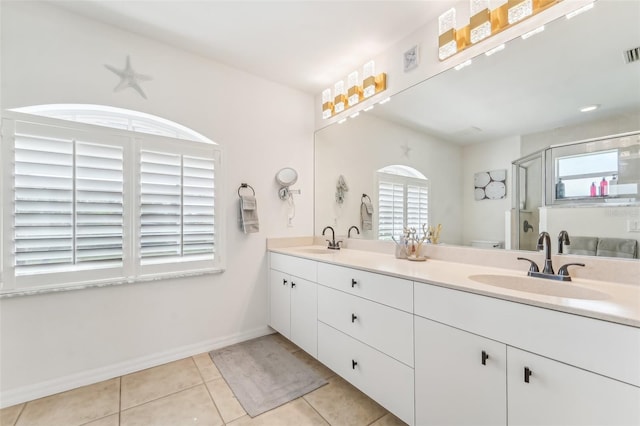 bathroom with tile patterned flooring, vanity, toilet, and walk in shower