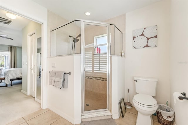 bathroom featuring tile patterned floors, ceiling fan, toilet, and walk in shower