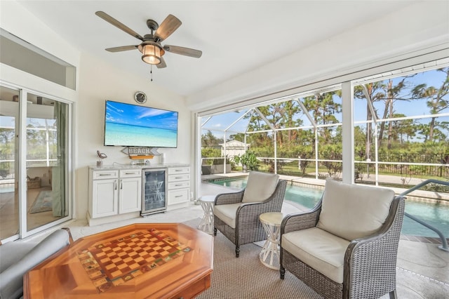 sunroom / solarium featuring ceiling fan and beverage cooler