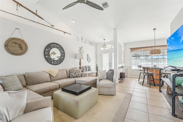 tiled living room featuring ceiling fan and vaulted ceiling