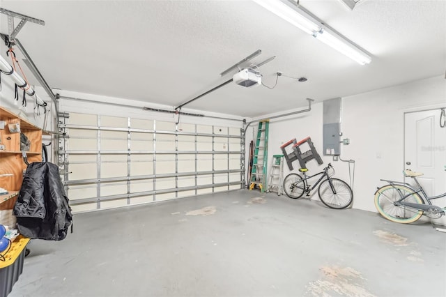 garage with a garage door opener and electric panel