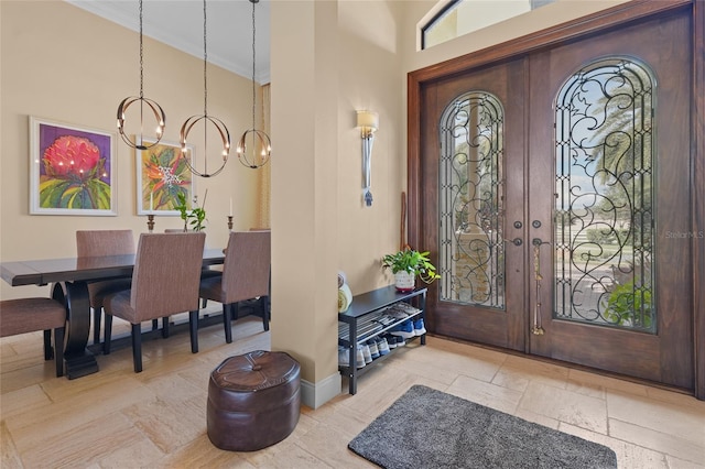 entryway featuring an inviting chandelier and high vaulted ceiling