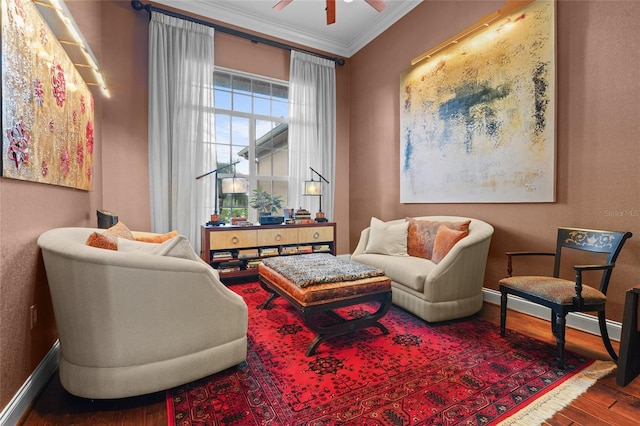 living area featuring ceiling fan, hardwood / wood-style floors, and ornamental molding