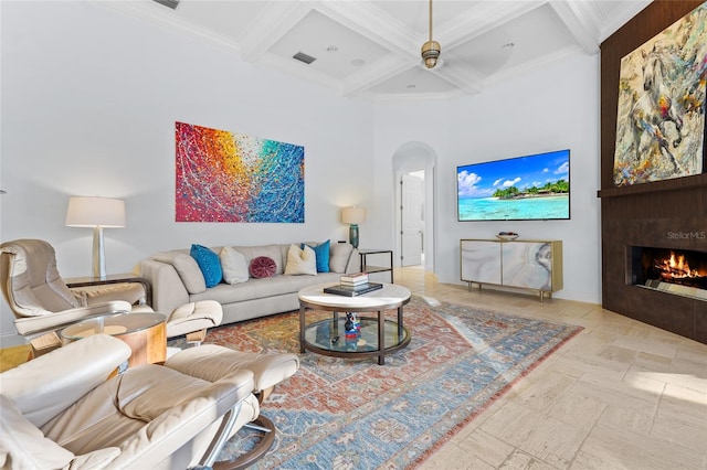 living room featuring ceiling fan, crown molding, beam ceiling, and coffered ceiling