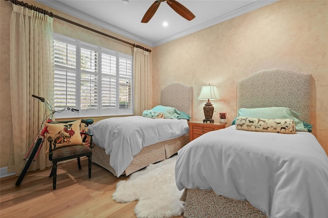 bedroom with ornamental molding, light hardwood / wood-style floors, and ceiling fan