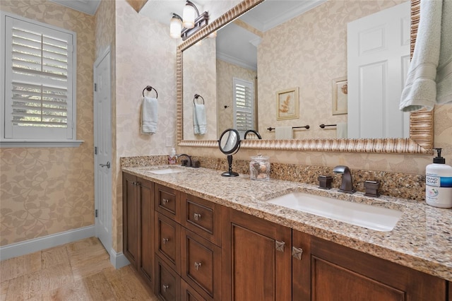 bathroom featuring vanity, a healthy amount of sunlight, and ornamental molding