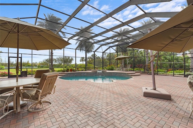 view of swimming pool featuring a lanai, an in ground hot tub, and a patio area