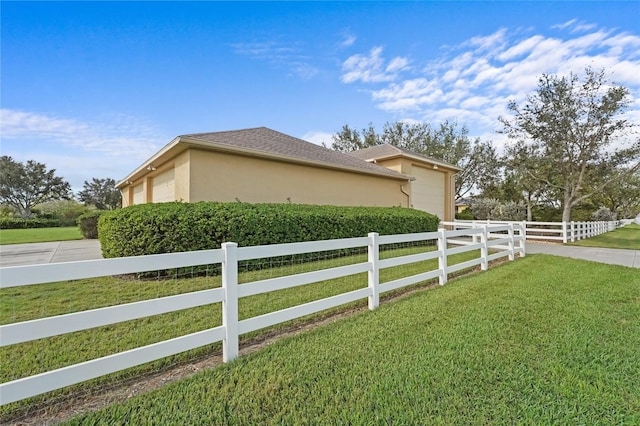 view of home's exterior featuring a garage and a lawn