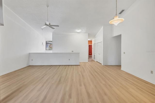 unfurnished living room featuring lofted ceiling, ceiling fan, and light hardwood / wood-style flooring