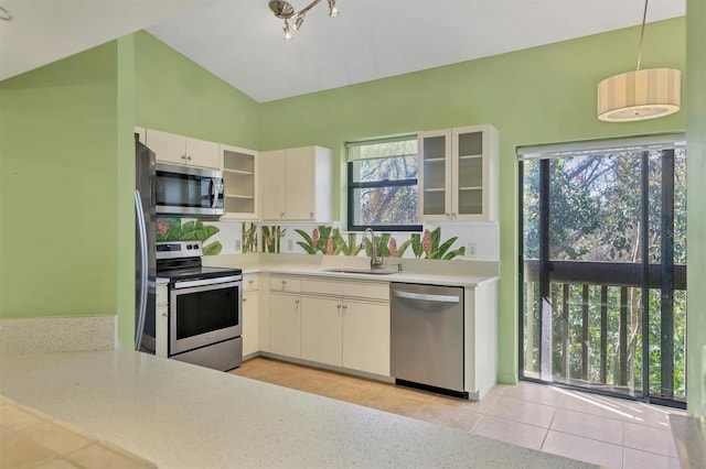 kitchen with hanging light fixtures, appliances with stainless steel finishes, sink, and plenty of natural light