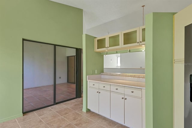 kitchen with white cabinetry and light tile patterned floors