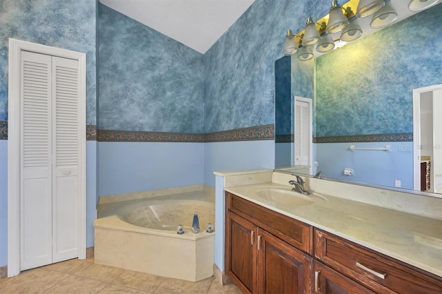 bathroom featuring a tub to relax in, vanity, and tile patterned flooring