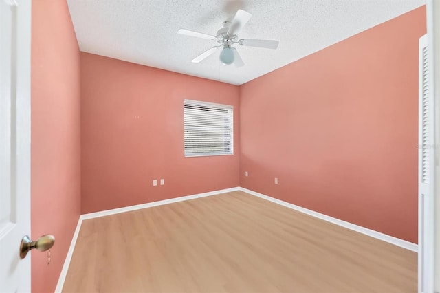 spare room with ceiling fan, hardwood / wood-style floors, and a textured ceiling