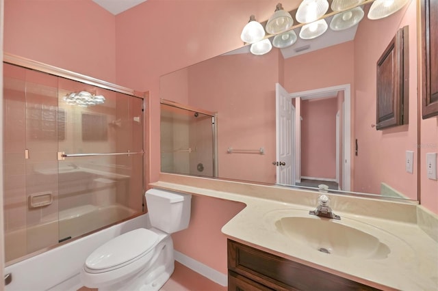 full bathroom with enclosed tub / shower combo, vanity, and toilet