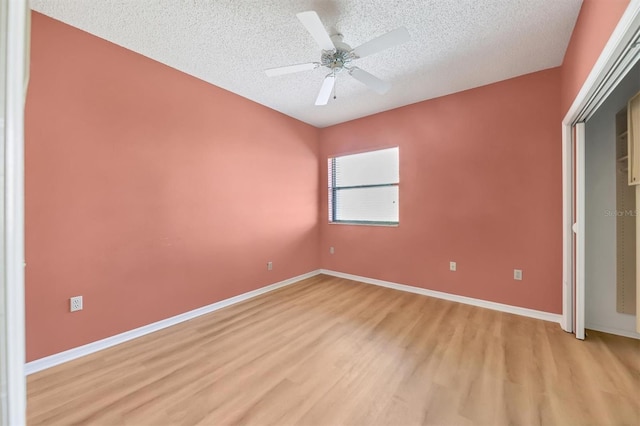 unfurnished bedroom with ceiling fan, a textured ceiling, and light hardwood / wood-style flooring