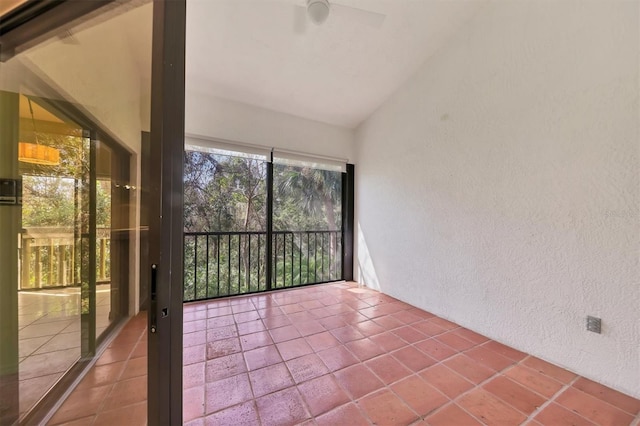 unfurnished sunroom with ceiling fan and lofted ceiling