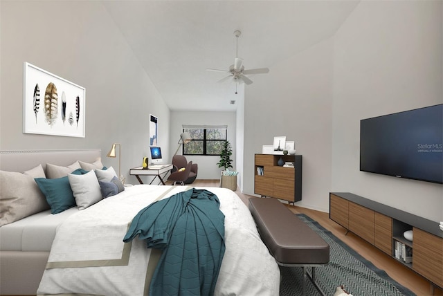 bedroom featuring hardwood / wood-style flooring, ceiling fan, and high vaulted ceiling